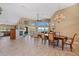 Spacious living room with a fireplace, dining table and chairs, and views of the water at 12432 Nova Ave, Port Charlotte, FL 33981