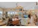 Bright living room with large windows offering serene lake views, cozy seating, and stylish ceiling fans at 12432 Nova Ave, Port Charlotte, FL 33981