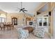 Living room featuring four armchairs, a stone fireplace, and large windows with outside views at 12432 Nova Ave, Port Charlotte, FL 33981