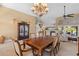 Spacious living and dining area with tile floors and views of the water through sliding glass doors at 12432 Nova Ave, Port Charlotte, FL 33981