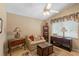 Cozy living room with neutral tones, ceiling fan, and charming furnishings at 12432 Nova Ave, Port Charlotte, FL 33981