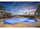 Screened pool and spa offer stunning waterfront views and an inviting outdoor oasis at 12432 Nova Ave, Port Charlotte, FL 33981