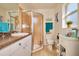 Well-lit bathroom showcasing a glass-enclosed shower, decorative accents, and a tiled floor at 127 Linda Lee Dr, Rotonda West, FL 33947