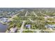 An aerial view showcases a neighborhood with beautiful homes near waterways and lush greenery at 13379 Journal Ln, Port Charlotte, FL 33981