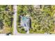 Aerial view of a well-kept property with a screened-in pool, attractive landscaping, and an inviting driveway at 13379 Journal Ln, Port Charlotte, FL 33981