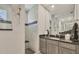 A well lit bathroom features granite counters, gray cabinets, and a walk-in shower at 13379 Journal Ln, Port Charlotte, FL 33981