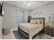 This bedroom has a ceiling fan, neutral decor, and a large sunny window at 13379 Journal Ln, Port Charlotte, FL 33981