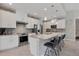 Gourmet kitchen boasts stainless appliances, gray backsplash, granite countertops and counter seating at 13379 Journal Ln, Port Charlotte, FL 33981