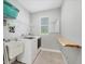 This laundry room offers ample space, washer/dryer, utility sink, and folding table at 13379 Journal Ln, Port Charlotte, FL 33981