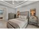 A main bedroom features neutral tones, a ceiling fan, and a tiled floor at 13379 Journal Ln, Port Charlotte, FL 33981