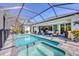 Enjoy outdoor living with a screened pool, spa, and patio area, ideal for entertaining and relaxation at 13379 Journal Ln, Port Charlotte, FL 33981