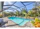 A stunning screened pool and spa with lush, tropical landscaping create a private outdoor oasis at 13379 Journal Ln, Port Charlotte, FL 33981
