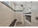 This shower features elegant stone trim, a built-in seat, and a rainfall shower head at 13379 Journal Ln, Port Charlotte, FL 33981