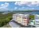 Stunning waterfront condo complex featuring colorful buildings, boat docks, and lush landscaping at 1420 Beach Rd # 203, Englewood, FL 34223