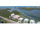 Aerial view of waterfront condos with a marina and beautiful water views at 1420 Beach Rd # 203, Englewood, FL 34223