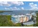Aerial view of multi-colored condominiums with water views, marina, and green space at 1420 Beach Rd # 203, Englewood, FL 34223