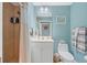 Bright bathroom featuring a walk-in shower, vanity with storage, and stylish decor at 1420 Beach Rd # 203, Englewood, FL 34223