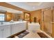 Bathroom features a dual sink vanity, soaking tub and glass enclosed shower at 1420 Beach Rd # 203, Englewood, FL 34223
