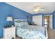 This bedroom has a bright blue accent wall with a door leading to the hallway at 1420 Beach Rd # 203, Englewood, FL 34223