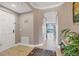 Inviting condo foyer featuring tile flooring, neutral walls, and a view towards the water at 1420 Beach Rd # 203, Englewood, FL 34223