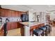 Modern kitchen with granite countertops, black appliances, and center island with seating for casual dining at 1420 Beach Rd # 203, Englewood, FL 34223