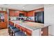 Well-equipped kitchen with dark wood cabinetry, granite countertops, and center island perfect for meal preparation at 1420 Beach Rd # 203, Englewood, FL 34223