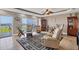 Spacious living room with plush seating, water view, and elegant decor creating a warm and inviting atmosphere at 1420 Beach Rd # 203, Englewood, FL 34223