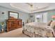 Bright main bedroom boasts tray ceilings and a private balcony entrance at 1420 Beach Rd # 203, Englewood, FL 34223