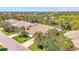Spacious homes in a lush community surrounded by mature trees, lakes, and manicured landscaping under a blue sky at 14270 Reserve Ct, Port Charlotte, FL 33953