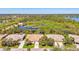 Breathtaking aerial view of homes near a large lake, surrounded by lush greenery and mature trees at 14270 Reserve Ct, Port Charlotte, FL 33953