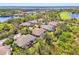 Scenic aerial view of homes with screened pools, lush landscaping, and nearby lakes at 14270 Reserve Ct, Port Charlotte, FL 33953