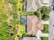Overhead aerial view featuring a home with a screened-in pool, surrounded by tropical landscaping at 14270 Reserve Ct, Port Charlotte, FL 33953