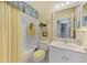 A well-lit bathroom featuring a shower-tub combination, a large mirror, and a sink with ample counter space at 14270 Reserve Ct, Port Charlotte, FL 33953