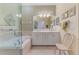 Bright bathroom boasts a large vanity, a soaking tub and a glass enclosed shower at 14270 Reserve Ct, Port Charlotte, FL 33953