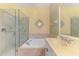 Bright bathroom boasts a large vanity, a soaking tub and a glass enclosed shower at 14270 Reserve Ct, Port Charlotte, FL 33953
