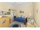 A cozy bedroom featuring a daybed with blue and yellow accents, and a charming decor with a wicker basket at 14270 Reserve Ct, Port Charlotte, FL 33953