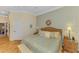 Comfortable bedroom boasts light walls, wood floors, and a large window at 14270 Reserve Ct, Port Charlotte, FL 33953
