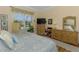 Comfortable bedroom boasts light walls, wood floors, and a large window with pond views at 14270 Reserve Ct, Port Charlotte, FL 33953