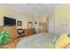 Comfortable bedroom boasts light walls, wood floors, and a large television at 14270 Reserve Ct, Port Charlotte, FL 33953