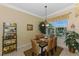 Bright dining room featuring a glass table, wicker chairs and views to the lanai and pool at 14270 Reserve Ct, Port Charlotte, FL 33953