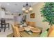 Bright dining room featuring a glass table, wicker chairs and views to the kitchen at 14270 Reserve Ct, Port Charlotte, FL 33953