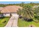 Inviting home with a well-maintained lawn, mature palm trees, and a spacious driveway at 14270 Reserve Ct, Port Charlotte, FL 33953
