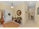 Inviting foyer featuring neutral tones, tile flooring, decorative lighting, and a hallway at 14270 Reserve Ct, Port Charlotte, FL 33953