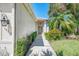 Inviting walkway leading to the home's entrance with manicured shrubs and plants at 14270 Reserve Ct, Port Charlotte, FL 33953