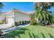 Well-maintained home featuring lush landscaping, a two-car garage, and exterior lighting at 14270 Reserve Ct, Port Charlotte, FL 33953