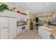 Functional kitchen with white appliances, ample cabinet space, and open view to dining area at 14270 Reserve Ct, Port Charlotte, FL 33953
