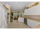 Bright and airy kitchen space with white cabinetry and views to adjacent dining area at 14270 Reserve Ct, Port Charlotte, FL 33953