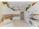 Bright kitchen featuring white appliances, neutral countertops, and decorative shelving accents at 14270 Reserve Ct, Port Charlotte, FL 33953