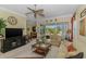 Spacious living room with a ceiling fan, comfortable seating, and backyard views at 14270 Reserve Ct, Port Charlotte, FL 33953