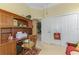 A charming home office with wooden desk, shelving, and adjacent closet for efficient storage solutions at 14270 Reserve Ct, Port Charlotte, FL 33953